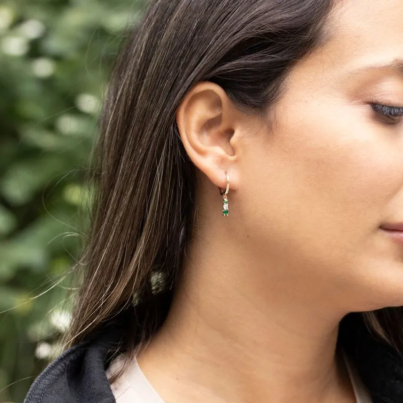 Yellow gold dangling earring with green and white zircons